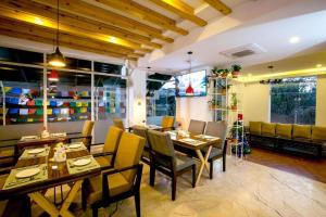 a restaurant with wooden tables and chairs and a christmas tree at Beautiful Kathmandu Swimming pool Hotel in Kathmandu