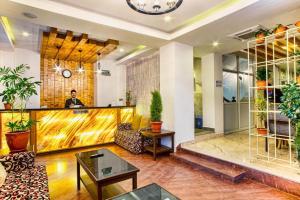 a man standing behind the bar in a living room at Beautiful Kathmandu Swimming pool Hotel in Kathmandu +10 photos