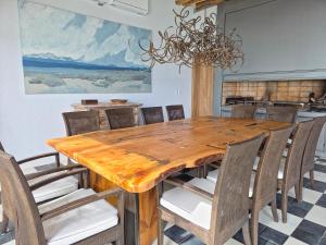 a dining room with a wooden table and chairs at Stipa Boutique Hotel in Chacras de Coria
