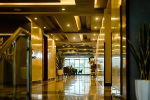 a lobby with a table and chairs in a building at Grand Plaza Hotel in Kampala