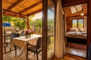 a room with a table and a bed on a balcony at Cirali Camping in Cıralı