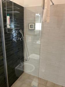 a bathroom with a glass shower with a toilet at Tenuta Serena Apartments in Molfetta +49 photos