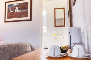 a room with a table with two dishes on it at The Hangklip Hotel in Pringle Bay
