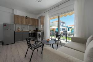 a living room with a couch and a table with chairs at SLV Dionysos Apartment in Ofrínion