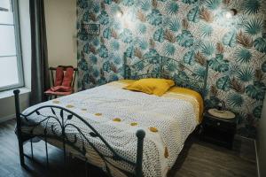 a bedroom with a bed with a yellow pillow on it at Le Key Largo in Cherbourg en Cotentin