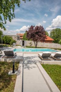 a swimming pool with lounge chairs in a yard at YAMM Pool House in Mali Požarevac