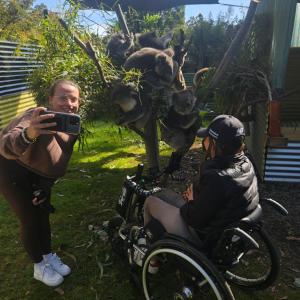 a man is taking a picture of a woman in a wheelchair at Fauna Australia Wildlife Experience in Lavers Hill