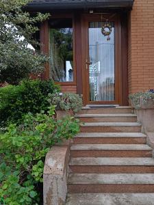 a staircase leading to a front door of a house at B&B Coccinella in Basiliano