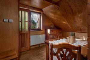 a dining room with a table and a window at Mały Domek in Stara Rzeka +17 photos