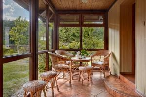 a screened in porch with a table and chairs at Mały Domek in Stara Rzeka