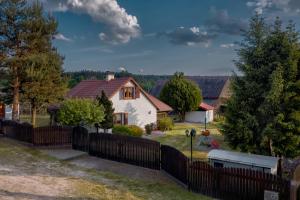 a house with a fence in front of it at Mały Domek in Stara Rzeka