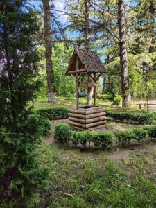a small wooden structure in the middle of a park at Tapan in Berd