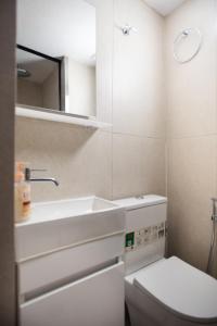 a small bathroom with a sink and a toilet at EMPHASIS Traditional House with Jacuzzi & Bicycles in Apodhoúlou +63 photos