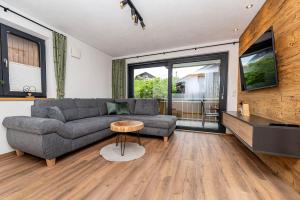 a living room with a couch and a table at Ferienwohnung Stuibock in Fischen