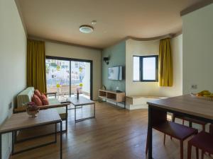 a living room with a couch and a table at Servatur Doña Elvira in Puerto Rico de Gran Canaria