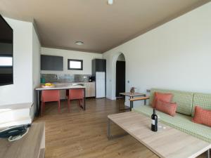 a living room with a couch and a table at Servatur Doña Elvira in Puerto Rico de Gran Canaria +16 photos