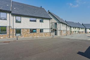a row of houses on a street at Residence Number 5 - Luxury 2 Bed Ground Floor Apartment By Together Travel in Nefyn