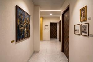 a hallway with paintings on the walls of a building at FabHotel Nilsa in Pālghar