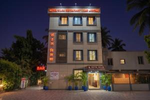 a building with a sign on top of it at FabHotel Nilsa in Pālghar