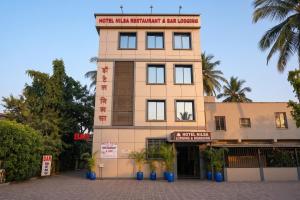 a building with a sign on top of it at FabHotel Nilsa in Pālghar