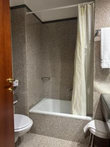 a bathroom with a bath tub and a toilet at Europa Dépendance in Isernia +3 photos