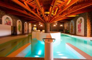 a pool in a building with a swimming pool at Wellness penzión Predná Hora in Muráň