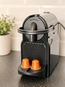 a toaster sitting on a counter with two orangeumbs at Grand Central House - Deluxe Studio - GibraltarStay Apartments in Gibraltar