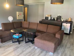 a living room with a couch and a table at Nordsjögården in Järvsö +6 photos