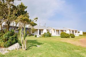 a house with a yard in front of it at The Hangklip Hotel in Pringle Bay
