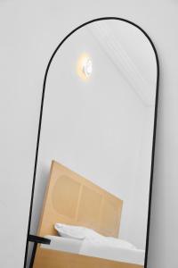 a mirror with a box on a shelf at IGBADUN House in Godomey +1 photo