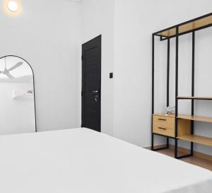 a bedroom with a bed and a black cabinet at IGBADUN House in Godomey