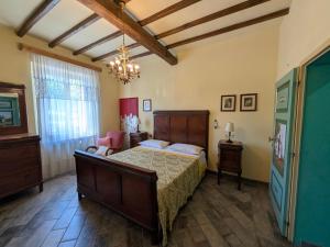 a bedroom with a large bed and a chandelier at La Francigena in Staggia +106 photos
