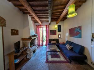 a living room with a blue couch and a table at La Francigena in Staggia