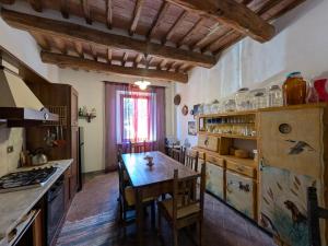 a kitchen with a wooden table and a counter top at La Francigena in Staggia