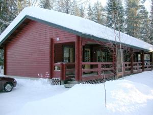 a red cabin with snow on top of it at Kutusumppu A in Tahkovuori
