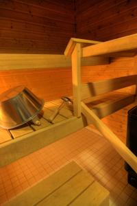 a wooden room with a metal tray on the floor at Kutusumppu A in Tahkovuori +2 photos