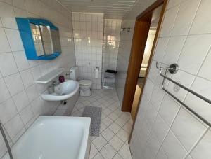 a bathroom with a toilet and a sink and a shower at Zentral Z in Siegen