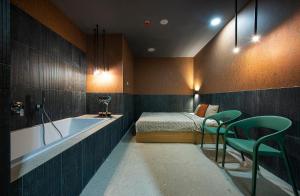 a bathroom with a tub and a bed and a bedroom at Wellness penzión Predná Hora in Muráň +35 photos