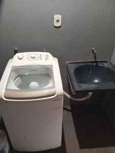 a small bathroom with a toilet and a sink at Casa de férias Pôr do Sol 4 in Bataguaçu +29 photos