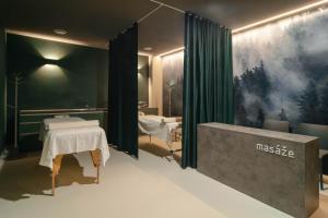 a massage room with two massage tables in a room at Wellness penzión Predná Hora in Muráň