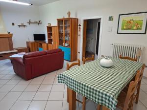 a living room with a table and a couch at La CASA degli IPPOCASTANI in Colonnella