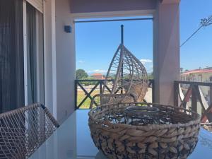 a basket on a balcony with a view of the outside at Mersea deluxe apartment Kourouta in Kourouta