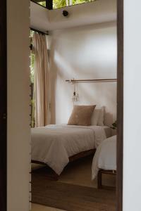 a bedroom with a bed and a window at Nalu Nosara Pool Villa Flor in Nosara +12 photos