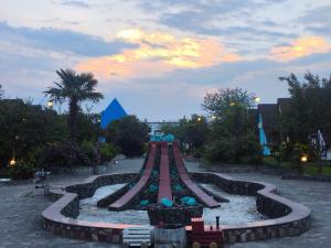 a roller coaster in a park at sunset at Relax Beach Astara in Astara