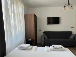 a living room with a bed and a couch at Parli Hotel in Gokceada Town +32 photos