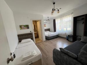 a living room with a bed and a couch at Parli Hotel in Gokceada Town