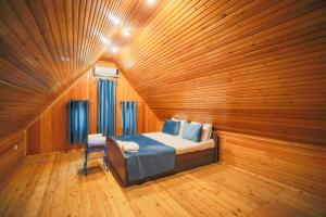 a bedroom with a bed and a wooden wall at Relax Beach Astara in Astara