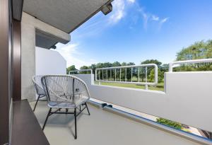 a balcony with two chairs and a table at Ferienwohnung 210 Salinenparc Design Budget Hotel in Erwitte