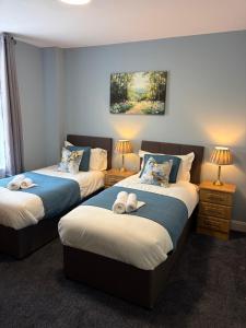 a bedroom with two beds with towels on them at The Pod on John St in Wexford