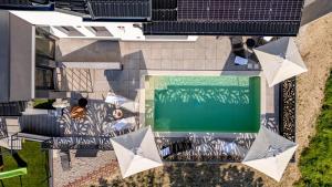 an overhead view of a swimming pool with umbrellas at Northern Croatia Accessible Luxury Villa in Cestica